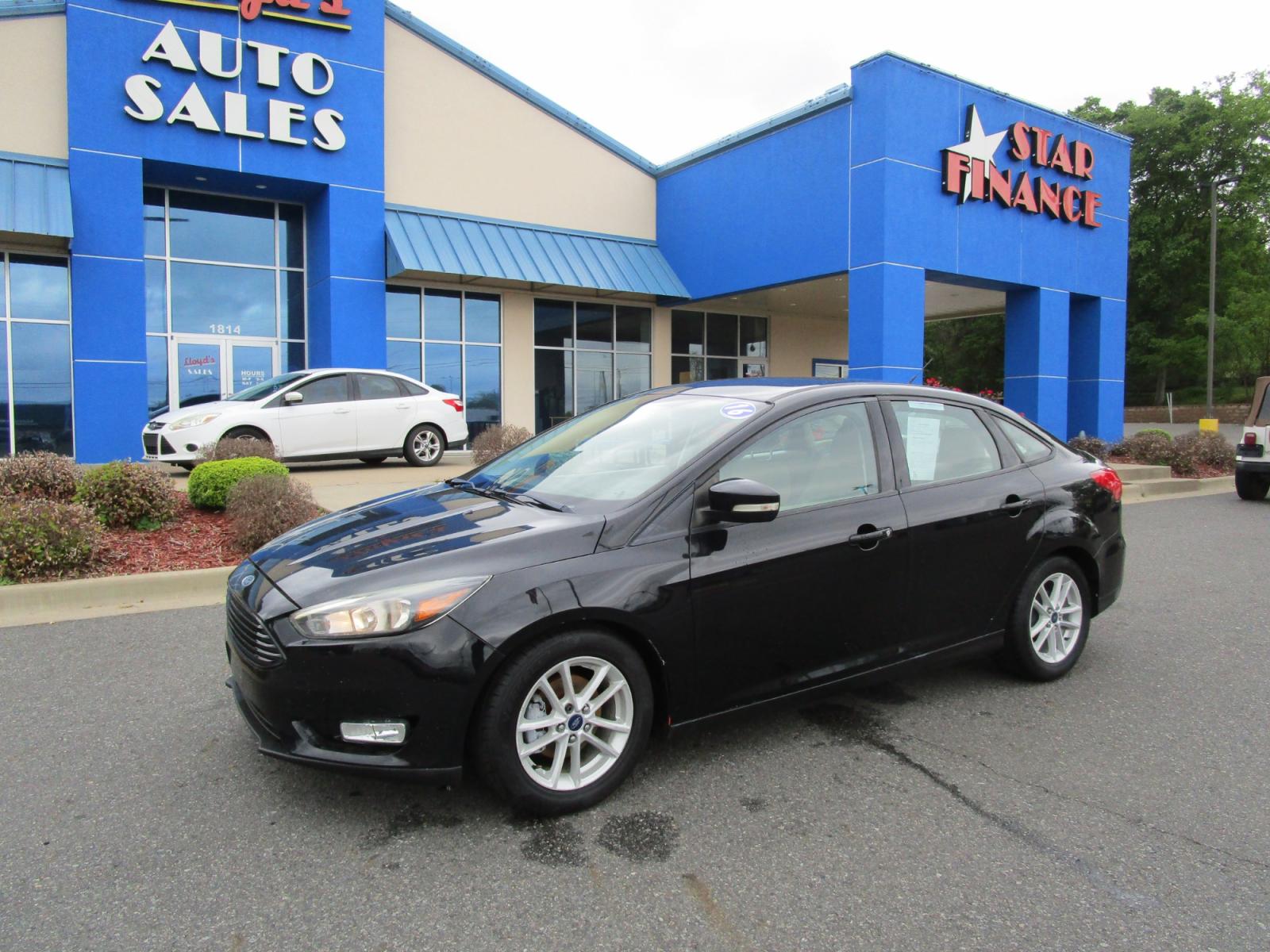 2016 BLACK /Gray / Cloth Ford Focus SE Sedan (1FADP3F22GL) with an 2.0L L4 DOHC 16V engine, located at 1814 Albert Pike Road, Hot Springs, AR, 71913, (501) 623-1717, 34.494228, -93.094070 - Photo #1