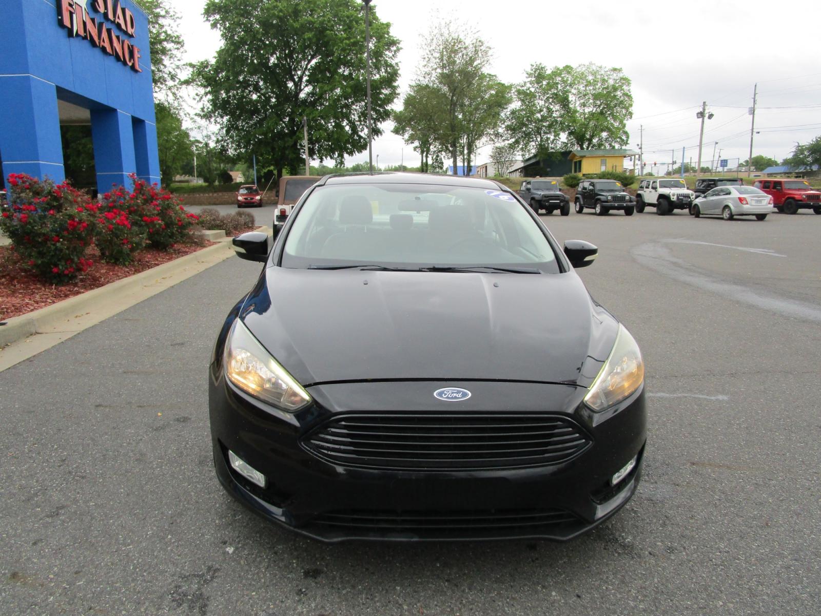 2016 BLACK /Gray / Cloth Ford Focus SE Sedan (1FADP3F22GL) with an 2.0L L4 DOHC 16V engine, located at 1814 Albert Pike Road, Hot Springs, AR, 71913, (501) 623-1717, 34.494228, -93.094070 - Photo #2