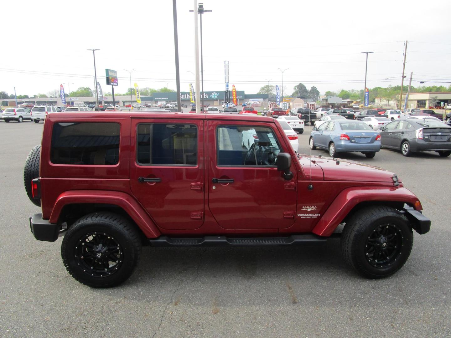 2013 MAROON /Black / Leather Jeep Wrangler Unlimited Sahara 4WD (1C4BJWEG9DL) with an 3.6L V6 DOHC 24V FFV engine, located at 1814 Albert Pike Road, Hot Springs, AR, 71913, (501) 623-1717, 34.494228, -93.094070 - Photo#2