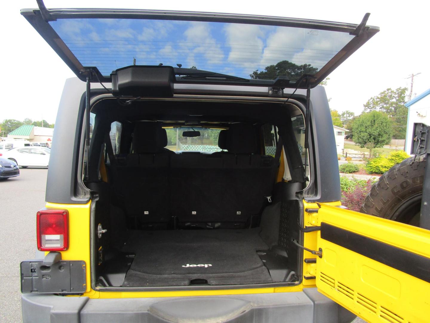 2015 Yellow /YELLOW/BLACK Jeep Wrangler Unlimited Sport 4WD (1C4BJWDG8FL) with an 3.6L V6 DOHC 24V FFV engine, located at 1814 Albert Pike Road, Hot Springs, AR, 71913, (501) 623-1717, 34.494228, -93.094070 - 2015 Jeep Wrangler Unlimited Sport 4X4 3.6L V6 24-Valve VVT Engine. 5 Speed Automatic Transmission. Exterior Features: "Trail Rated" Badge. Sunrider Soft Top. Full Metal Doors with Roll-up Windows. Fog Lamps. 2 Front Tow Hooks and 1 Rear Tow Hook. Interior Features: Rearview Day/Night Mirr - Photo#11