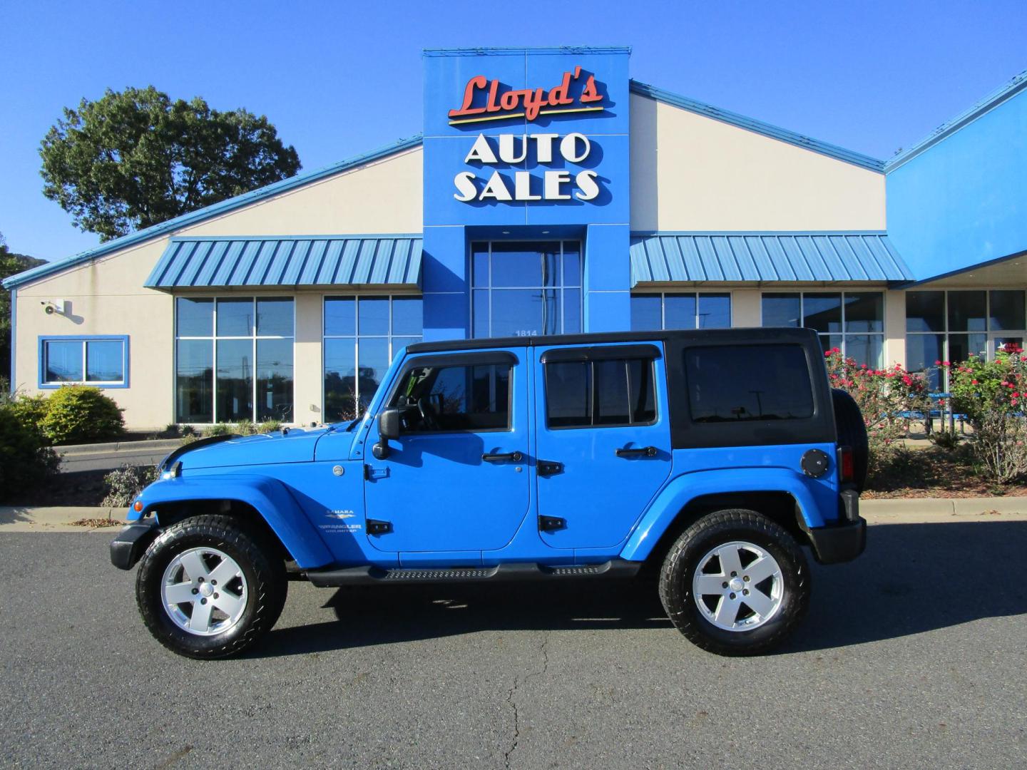 2011 Blue /Black/Cloth Jeep Wrangler Unlimited Sahara 4WD (1J4BA5H10BL) with an 3.8L V6 OHV 12V engine, located at 1814 Albert Pike Road, Hot Springs, AR, 71913, (501) 623-1717, 34.494228, -93.094070 - Photo#0