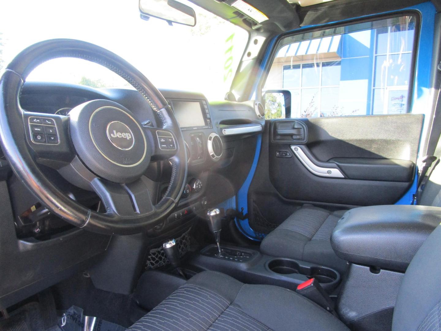 2011 Blue /Black/Cloth Jeep Wrangler Unlimited Sahara 4WD (1J4BA5H10BL) with an 3.8L V6 OHV 12V engine, located at 1814 Albert Pike Road, Hot Springs, AR, 71913, (501) 623-1717, 34.494228, -93.094070 - Photo#6