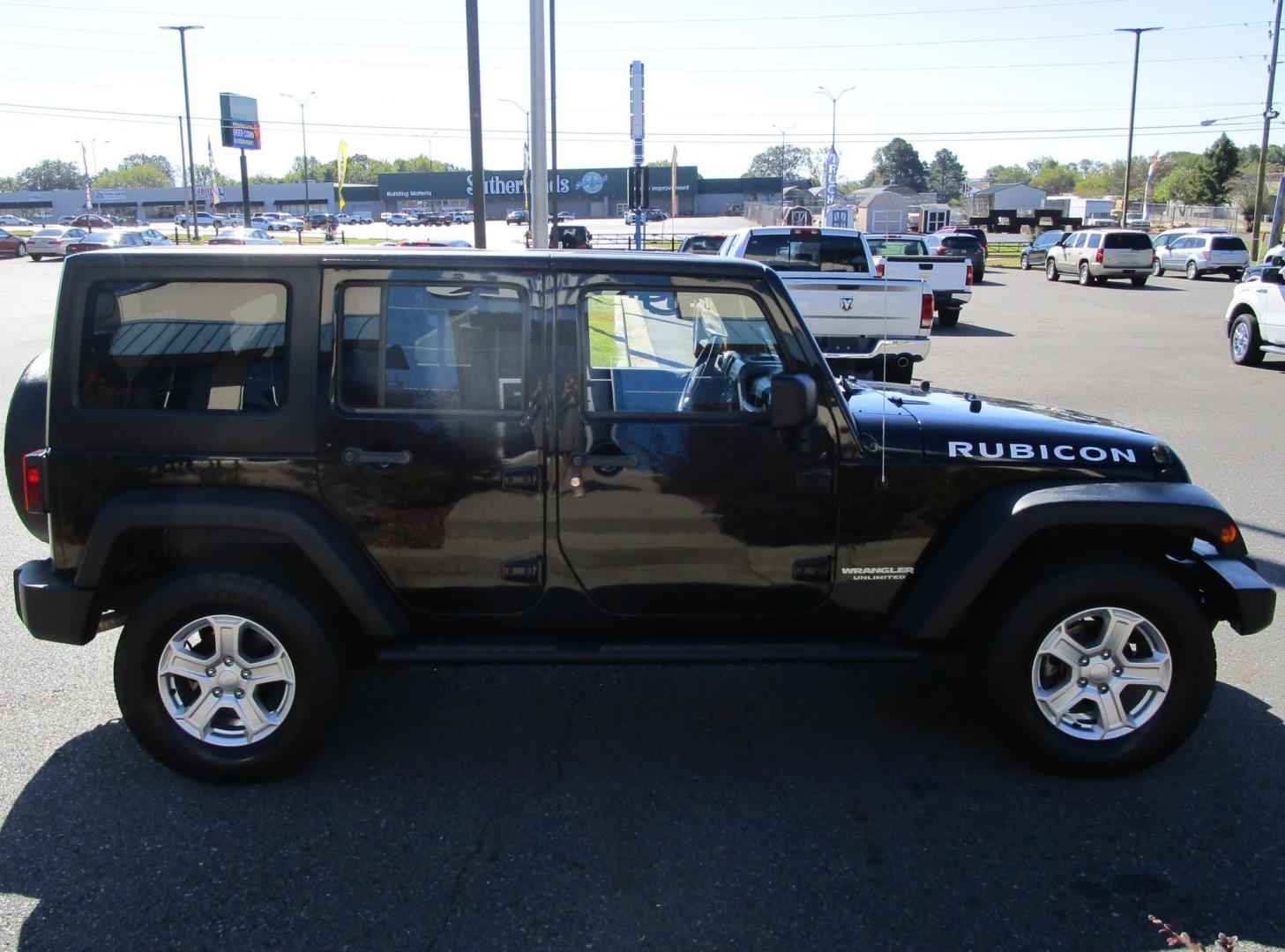 2011 BLACK /BLACK Jeep Wrangler Unlimited Rubicon 4WD (1J4BA6H18BL) with an 3.8L V6 OHV 12V engine, AUTOMATIC transmission, located at 1814 Albert Pike Road, Hot Springs, AR, 71913, (501) 623-1717, 34.494228, -93.094070 - Photo#4